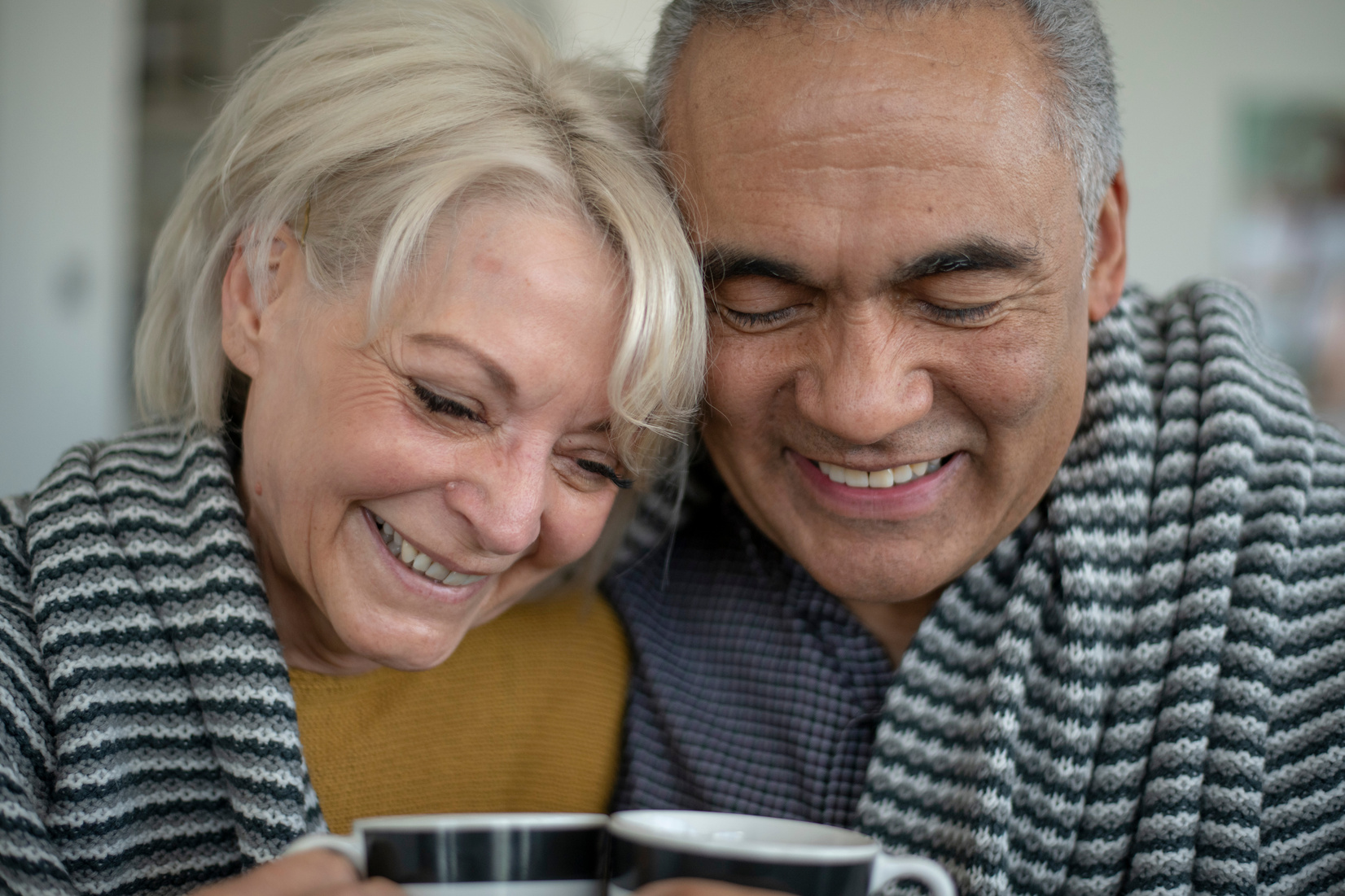 Baby boomers hugging on the couch